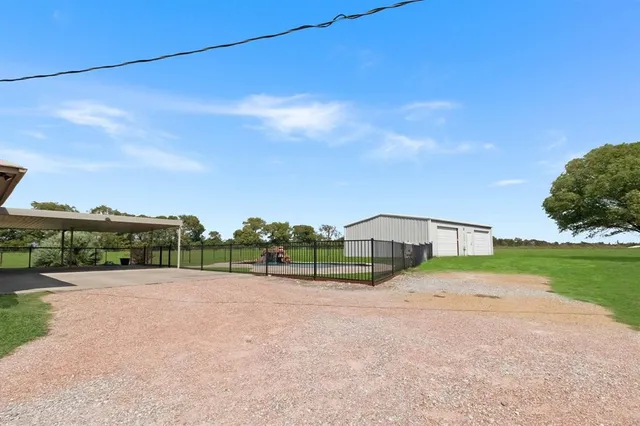 a view of a road with a big yard