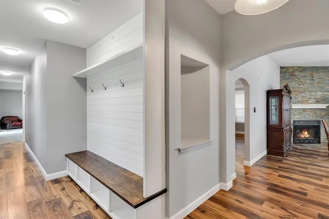 a view of a hallway with wooden floor and staircase