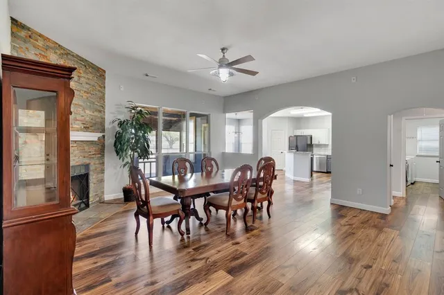 a view of a a dining room with furniture window and wooden floor