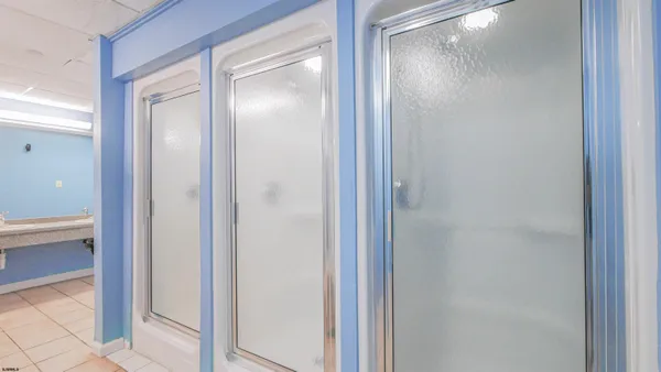 a spacious bathroom with a double vanity sink mirror and bathtub
