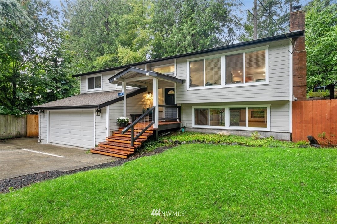 5680 Northeast Foster Road Bainbridge Island, WA 98110 - Photo 1 of 23 a front view of a house with a garden