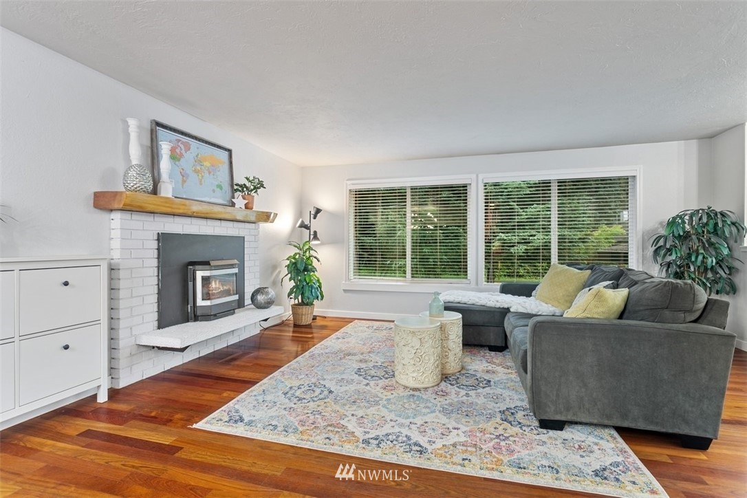 5680 Northeast Foster Road Bainbridge Island, WA 98110 - Photo 2 of 23 a living room with furniture and a fireplace