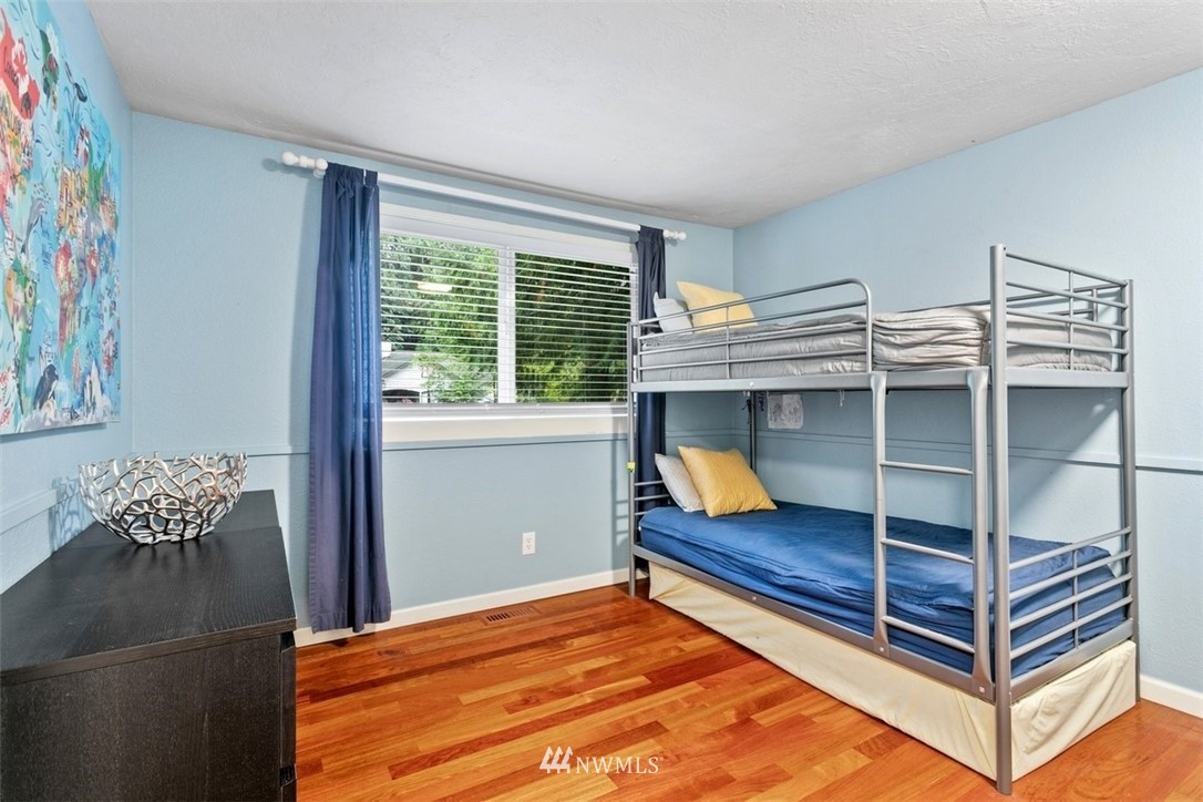 5680 Northeast Foster Road Bainbridge Island, WA 98110 - Photo 11 of 23 a bedroom with a bunk bed and a chair