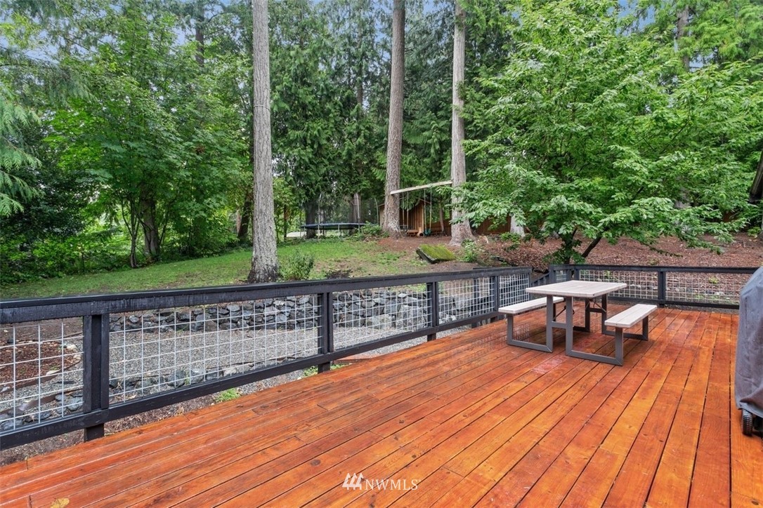 5680 Northeast Foster Road Bainbridge Island, WA 98110 - Photo 19 of 23 a view of a deck with chairs and wooden floor