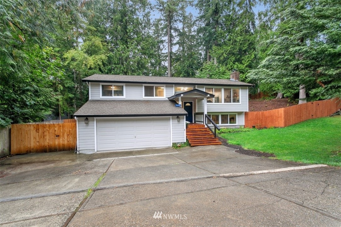 5680 Northeast Foster Road Bainbridge Island, WA 98110 - Photo 23 of 23 a front view of a house with a yard and garage