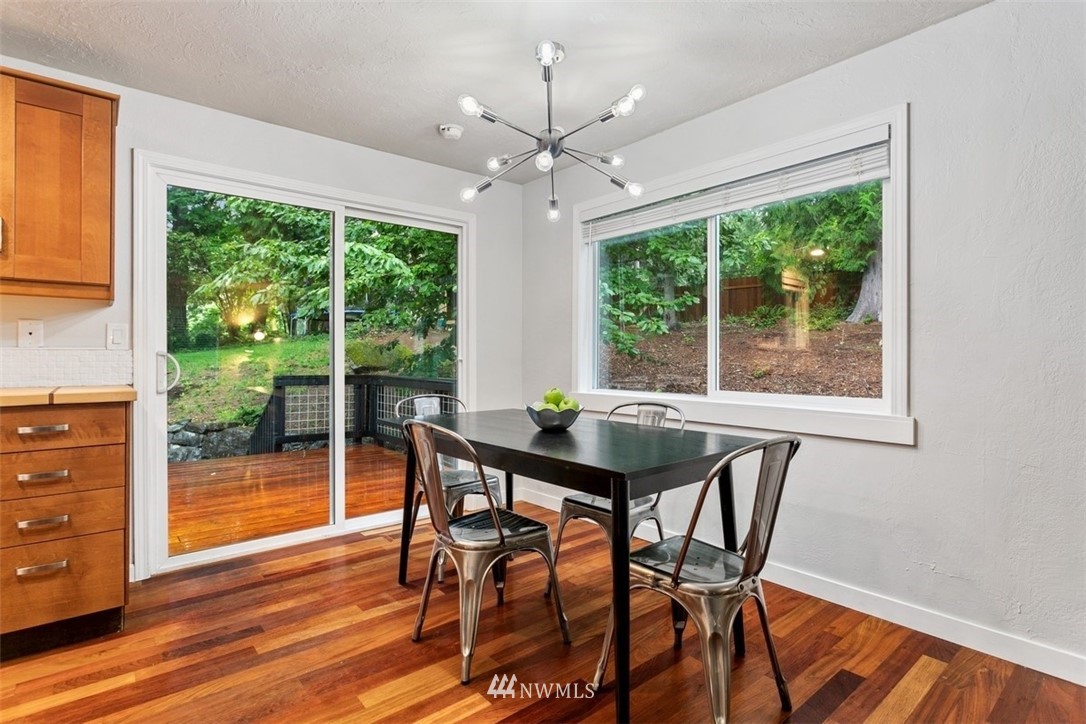 5680 Northeast Foster Road Bainbridge Island, WA 98110 - Photo 5 of 23 a view of a dining room with furniture window and wooden floor