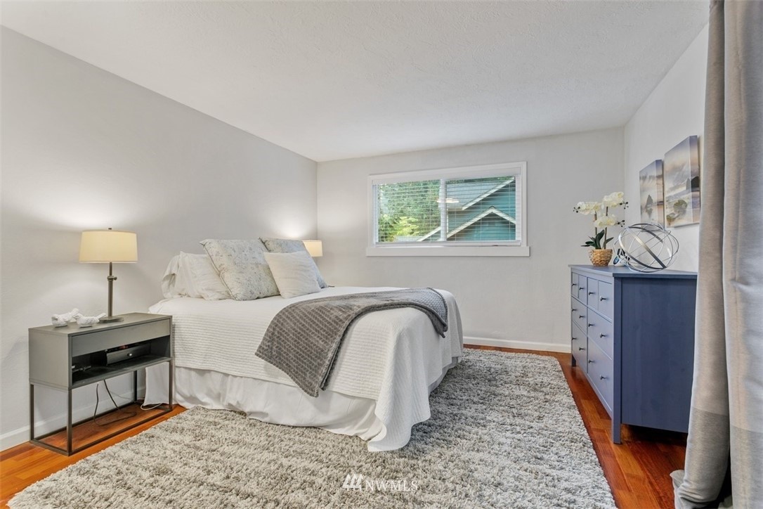 5680 Northeast Foster Road Bainbridge Island, WA 98110 - Photo 7 of 23 a bedroom with a bed and a mirror