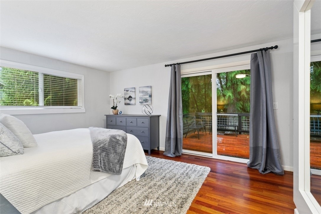 5680 Northeast Foster Road Bainbridge Island, WA 98110 - Photo 8 of 23 a bedroom with a large bed and a large window