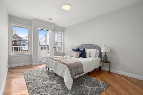 a bedroom with a large bed and a window