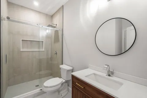 a bathroom with a sink a toilet and a mirror