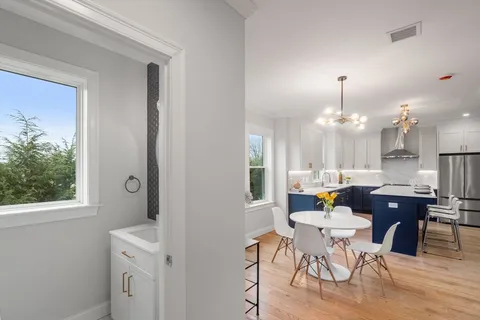 a view of a dining room with furniture and chandelier