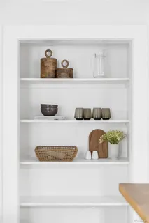 a kitchen with stainless steel appliances a table and chairs in it