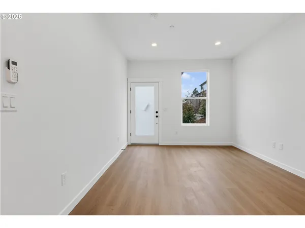 a view of kitchen with refrigerator and window