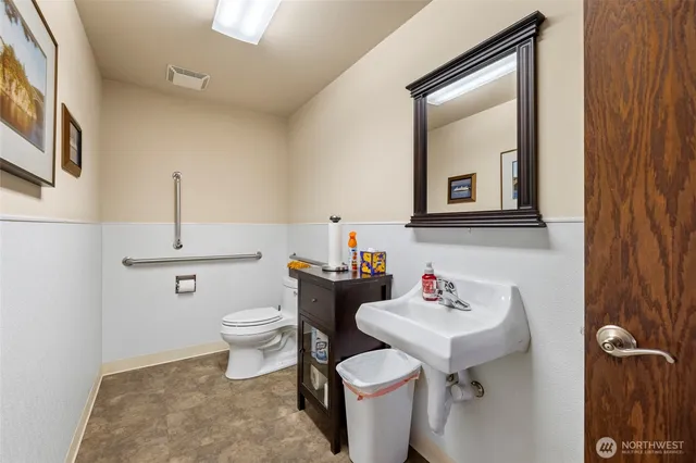 a bathroom with a sink toilet and mirror