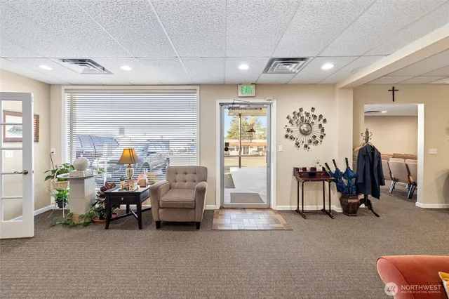 a bedroom with furniture and a large window