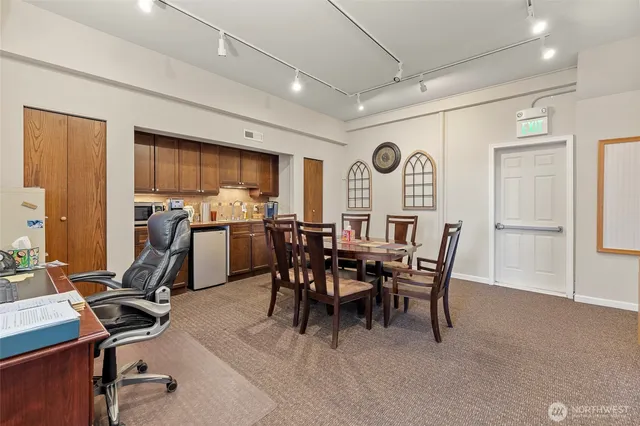a view of a dining room with furniture and a window