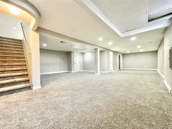 a bathroom with a sink a toilet a shower and a mirror