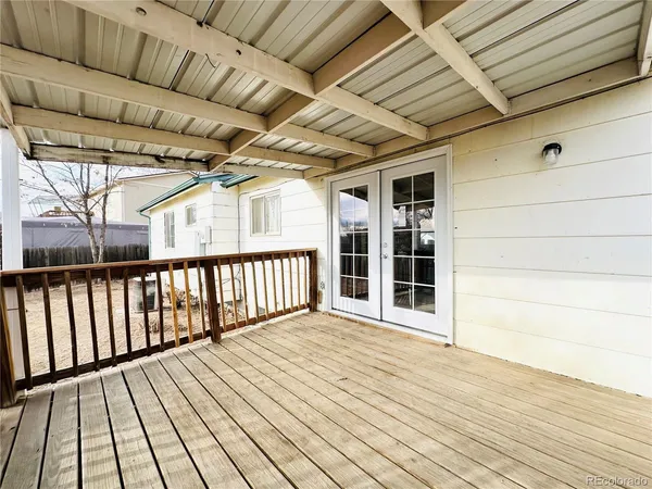 a view of house with yard and trees in the background