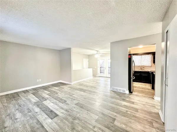 a kitchen with granite countertop stainless steel appliances a sink stove top oven and cabinets