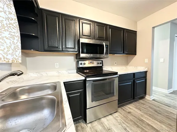 a kitchen with a refrigerator and a sink