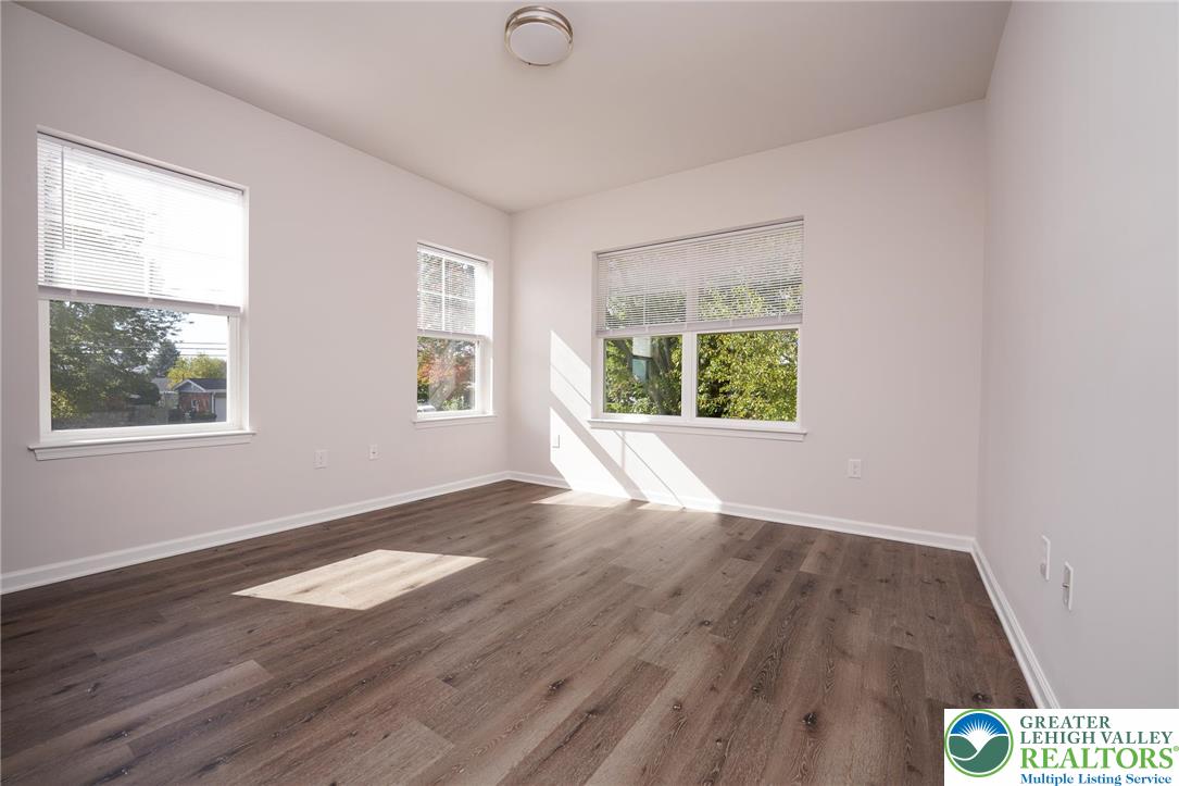 1210 Eaton Avenue, Unit 204 Bethlehem, PA 18018 - Photo 18 of 22 a view of an empty room with wooden floor and a window