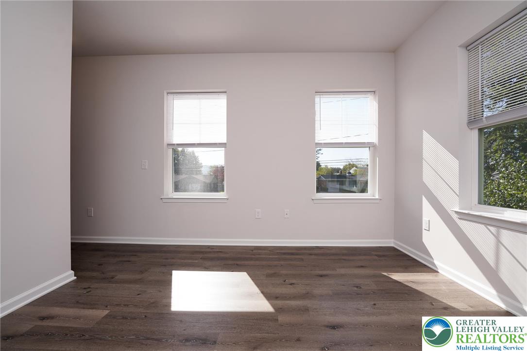 1210 Eaton Avenue, Unit 204 Bethlehem, PA 18018 - Photo 19 of 22 a view of an empty room with wooden floor and a window