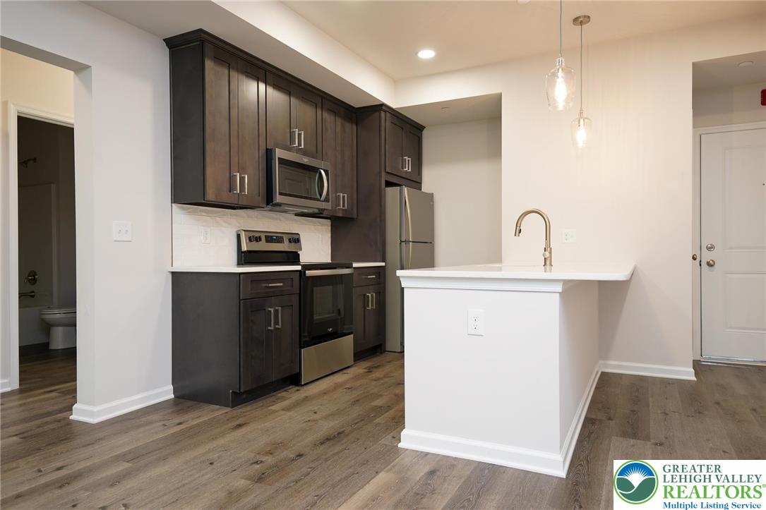 1210 Eaton Avenue, Unit 204 Bethlehem, PA 18018 - Photo 10 of 22 a kitchen with a sink a microwave a refrigerator and cabinets