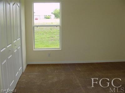 3111 35th Street Southwest Lehigh Acres, FL 33976 - Photo 8 of 10 an empty room with a window