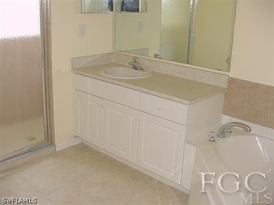 3111 35th Street Southwest Lehigh Acres, FL 33976 - Photo 9 of 10 a bathroom with a sink and a mirror