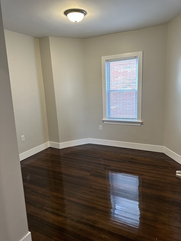 15 Tuttle Street, Unit 2 Revere, MA 02151 - Photo 7 of 17 a view of an empty room with wooden floor and a window