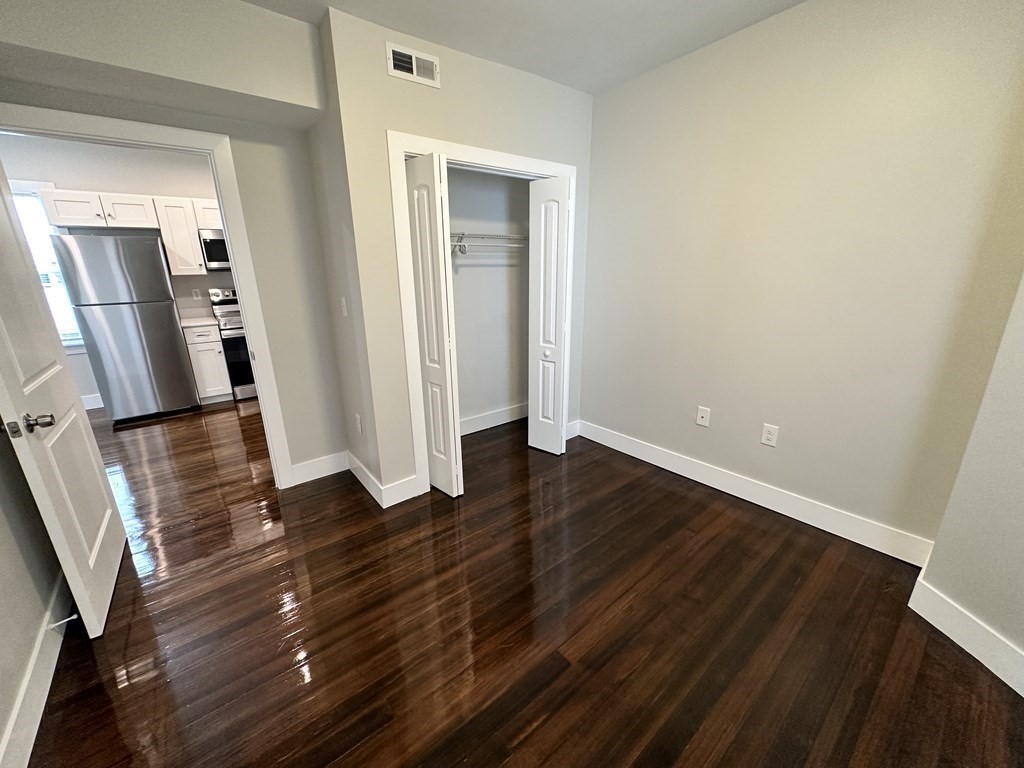 15 Tuttle Street, Unit 2 Revere, MA 02151 - Photo 8 of 17 wooden floor in an empty room