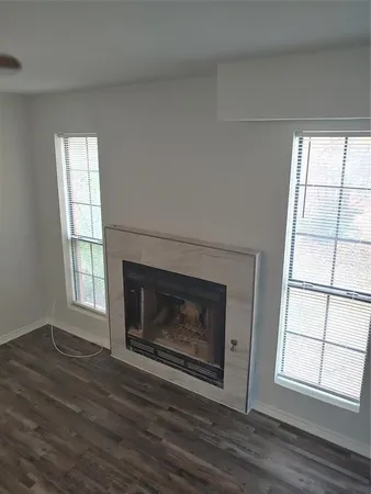 a living room with a fireplace and wooden floor