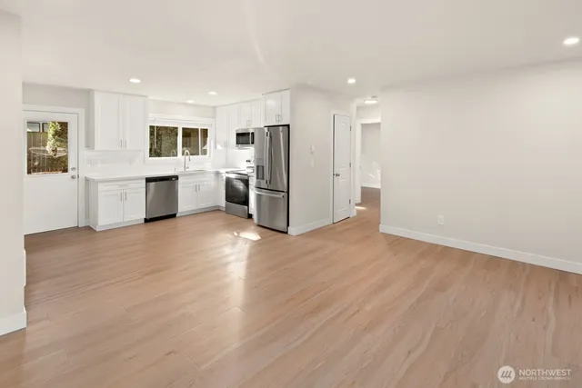 a view of kitchen with stainless steel appliances refrigerator oven and stove