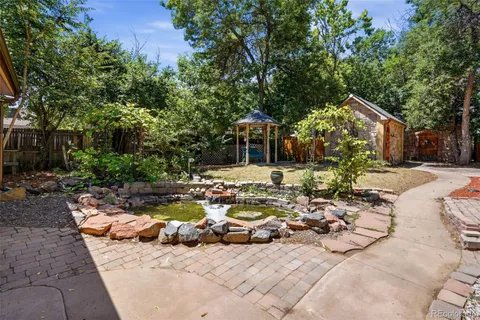 a view of a house with backyard water and sitting area