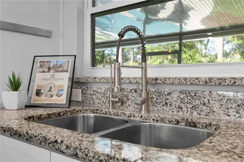 a view of a kitchen island with a sink and cabinets