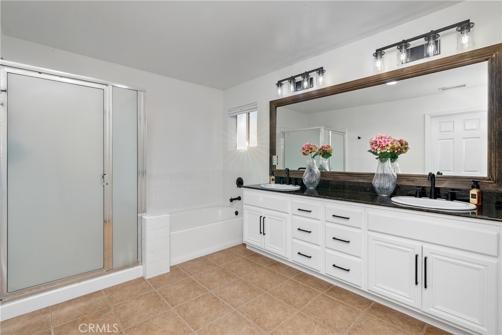 1926 Kleck Road Paso Robles, CA 93446 - Photo 16 of 29 a bathroom with a double vanity sink a mirror and a bathtub