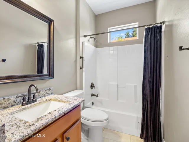a living room with fireplace furniture and a flat screen tv
