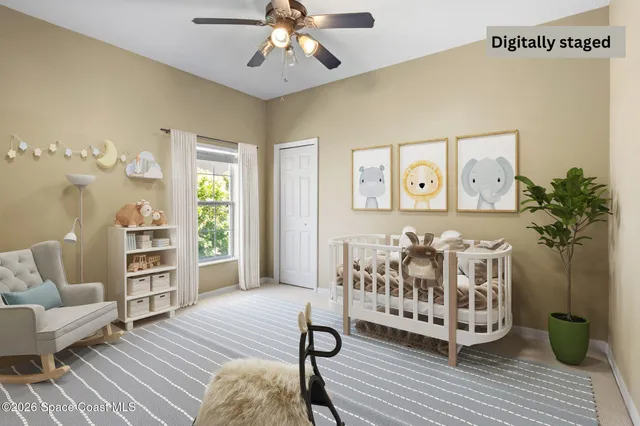 a view of an empty room with a ceiling fan