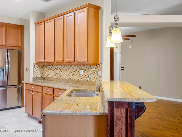 an aerial view of residential houses with outdoor space and ocean