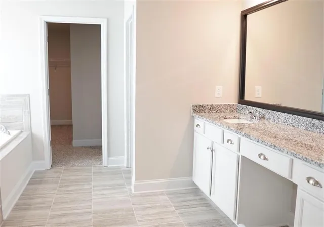 a view of staircase with railing and white walls