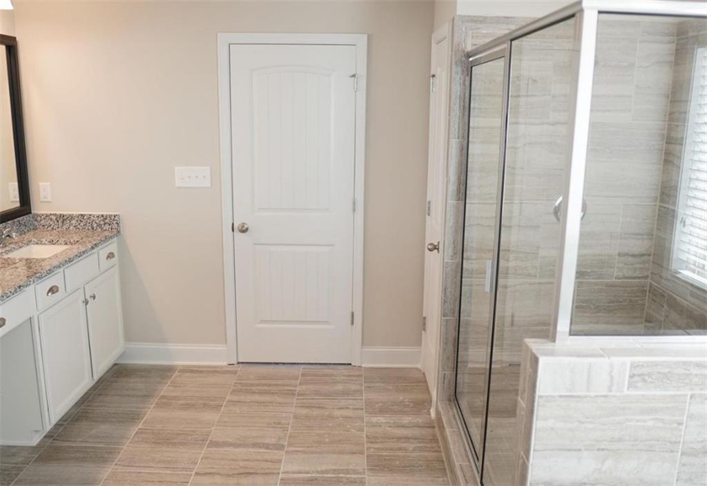 309 Bermuda Ridge Perry, GA 31069 - Photo 20 of 33 a bathroom with a granite countertop sink and a mirror