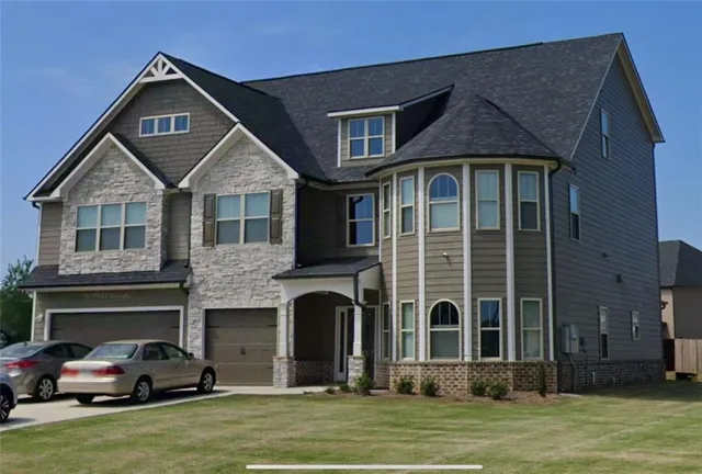 a front view of a house with a yard
