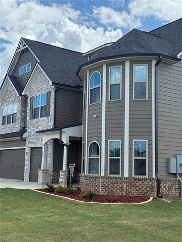 a front view of a house with a yard
