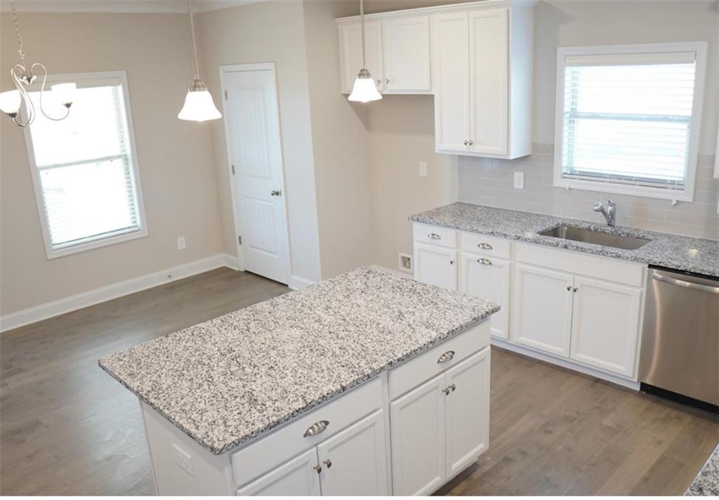 309 Bermuda Ridge Perry, GA 31069 - Photo 7 of 33 a kitchen with granite countertop sink and cabinets