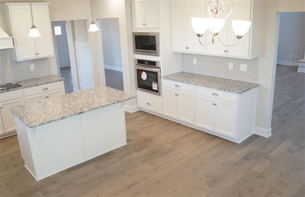 309 Bermuda Ridge Perry, GA 31069 - Photo 9 of 33 a kitchen with stainless steel appliances granite countertop a stove and a sink