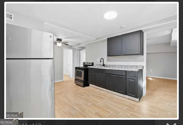 a kitchen with a refrigerator and a sink