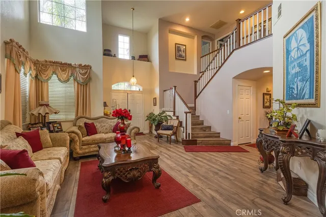 a living room with furniture and a chandelier
