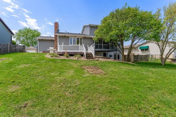 a house view with a sitting space and garden