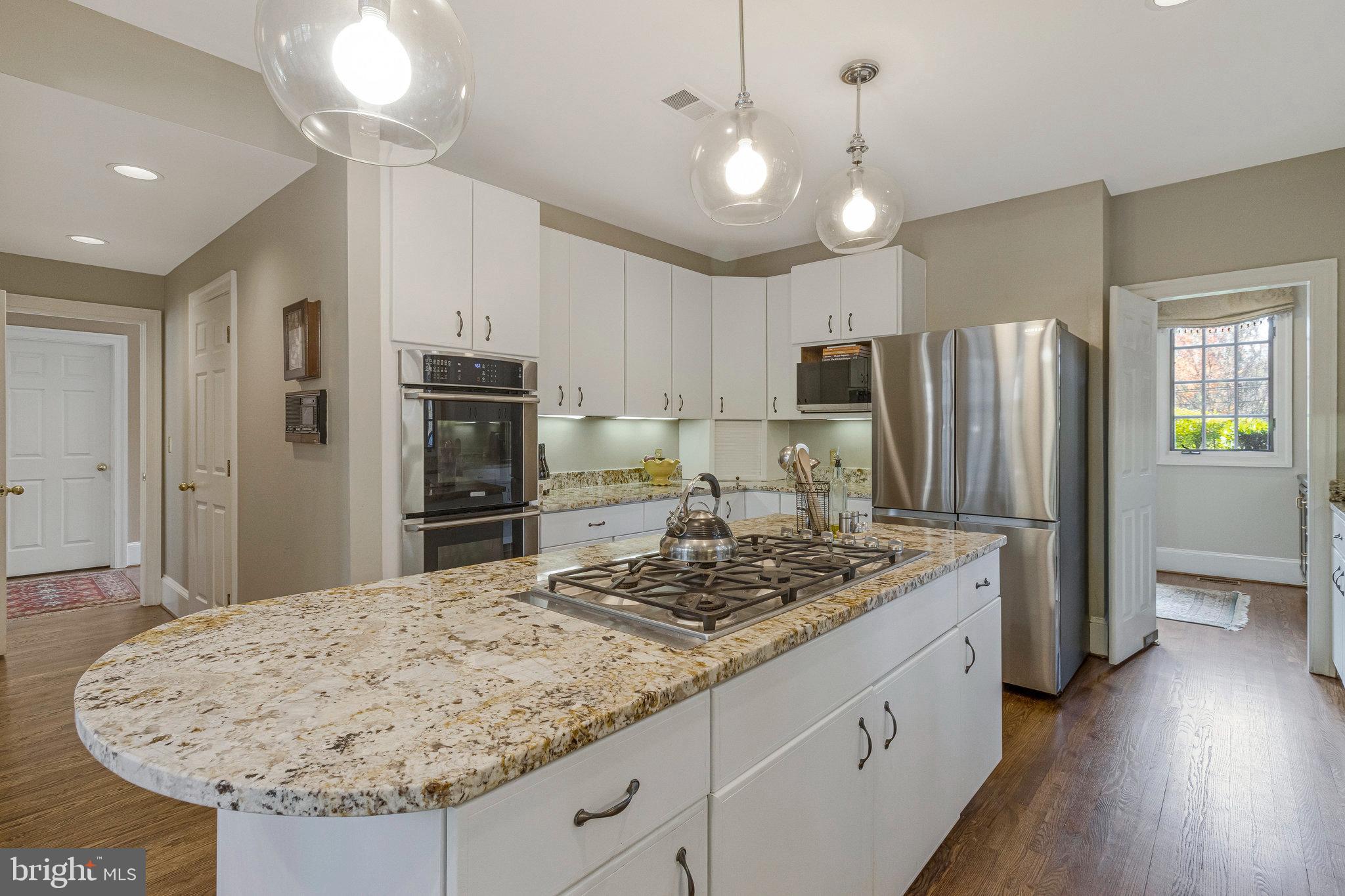 1655 Kalmia Road Northwest Washington, DC 20012 - Photo 14 of 71 a kitchen with stainless steel appliances granite countertop a sink refrigerator and cabinets
