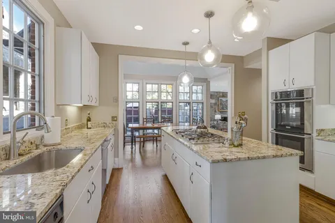a living room with furniture a flat screen tv and a large window